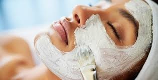 Woman receiving a glowing facial treatment
